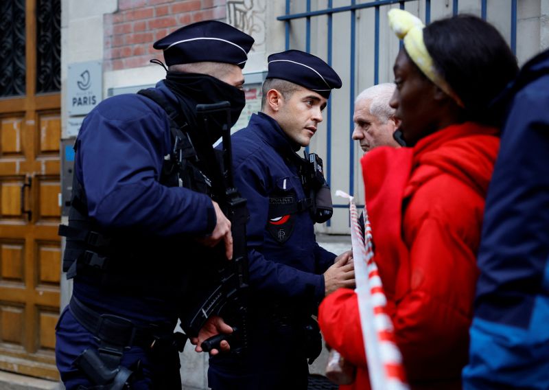 At the scene of the tragic Paris shooting, police use tear gas to disperse protesters